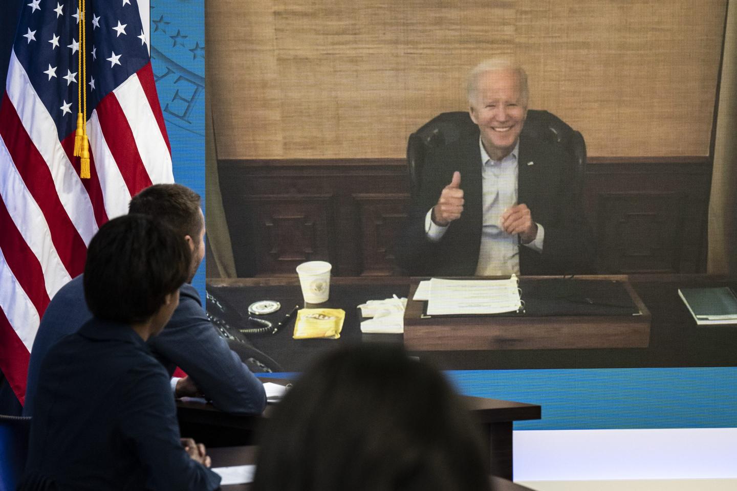 U.S. President Joe Biden gives the thumbs-up during a virtual meeting as he isolates after testing positive for COVID-19.