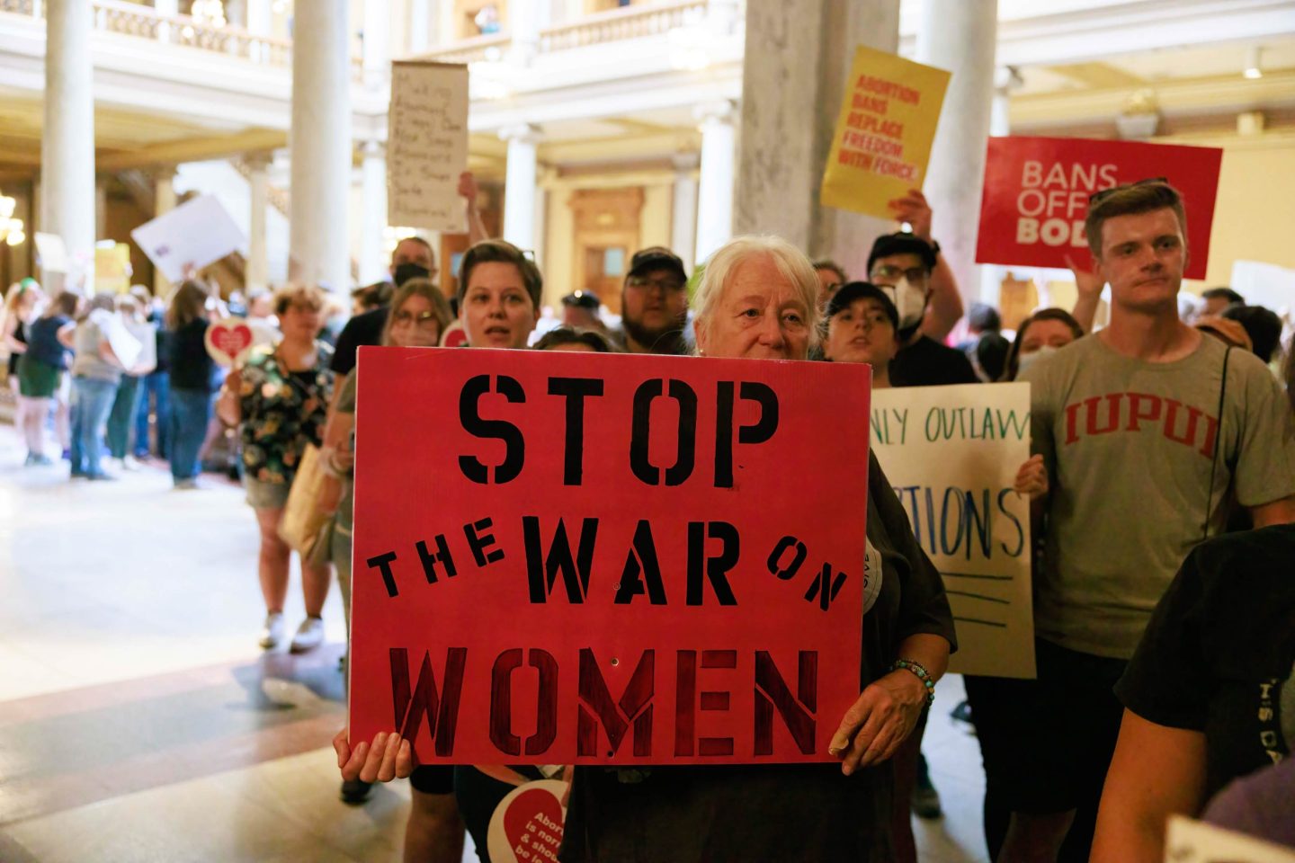Abortion-rights protesters demonstrate inside the Indiana State house.