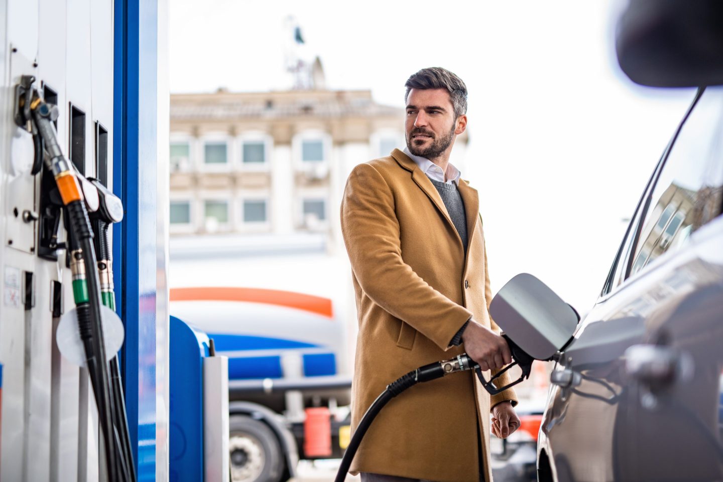 Elegant man refueling his car's tank at the gas station