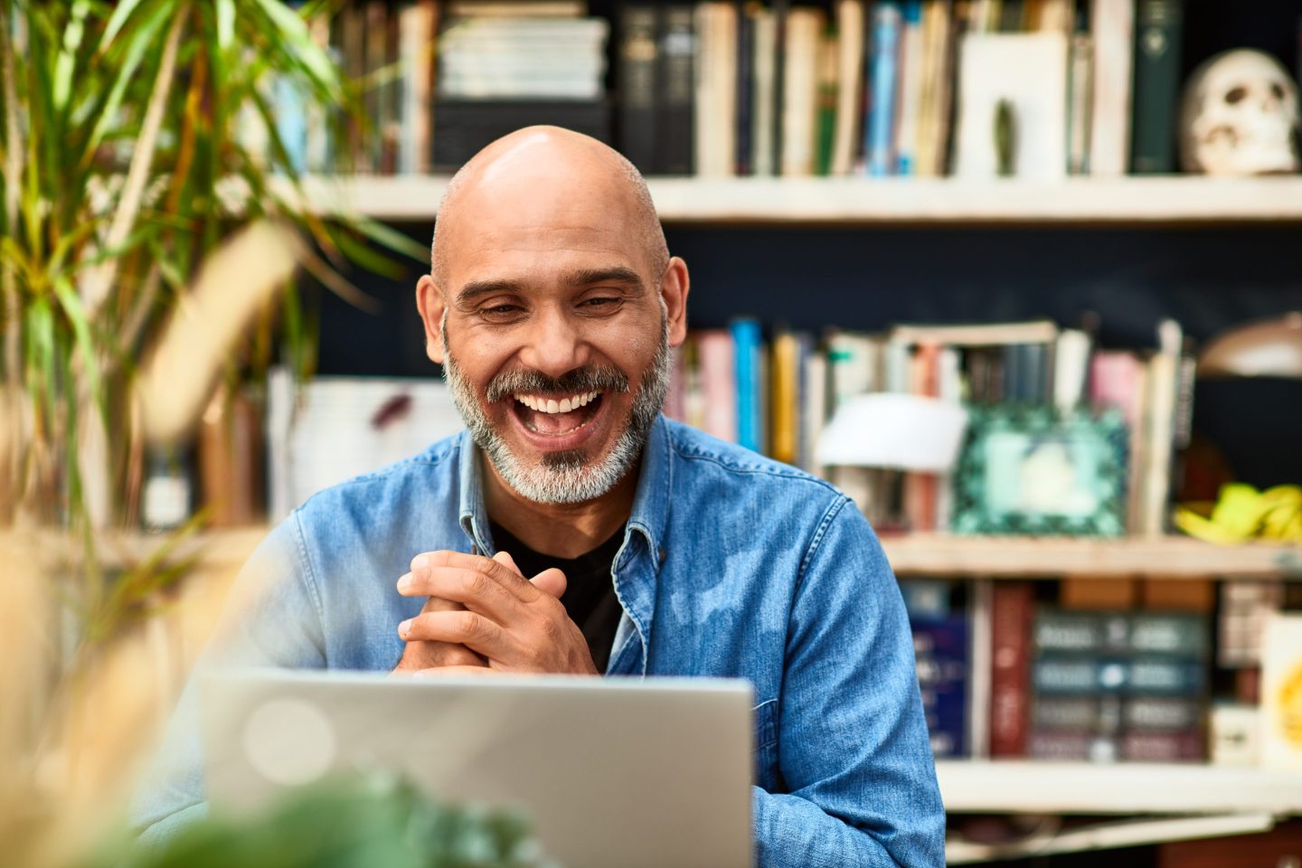 Man laughing while working from home