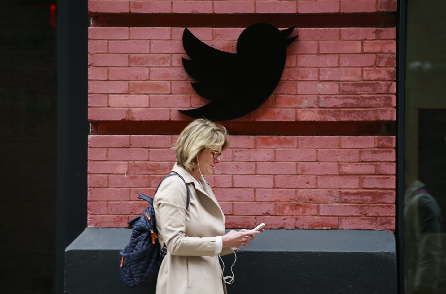 People walk by the Twitter office on April 26, 2022 in New York City. Billionaire Elon Musk, CEO of Tesla and Space X, reached an agreement to purchase social media platform Twitter for $44 billion.