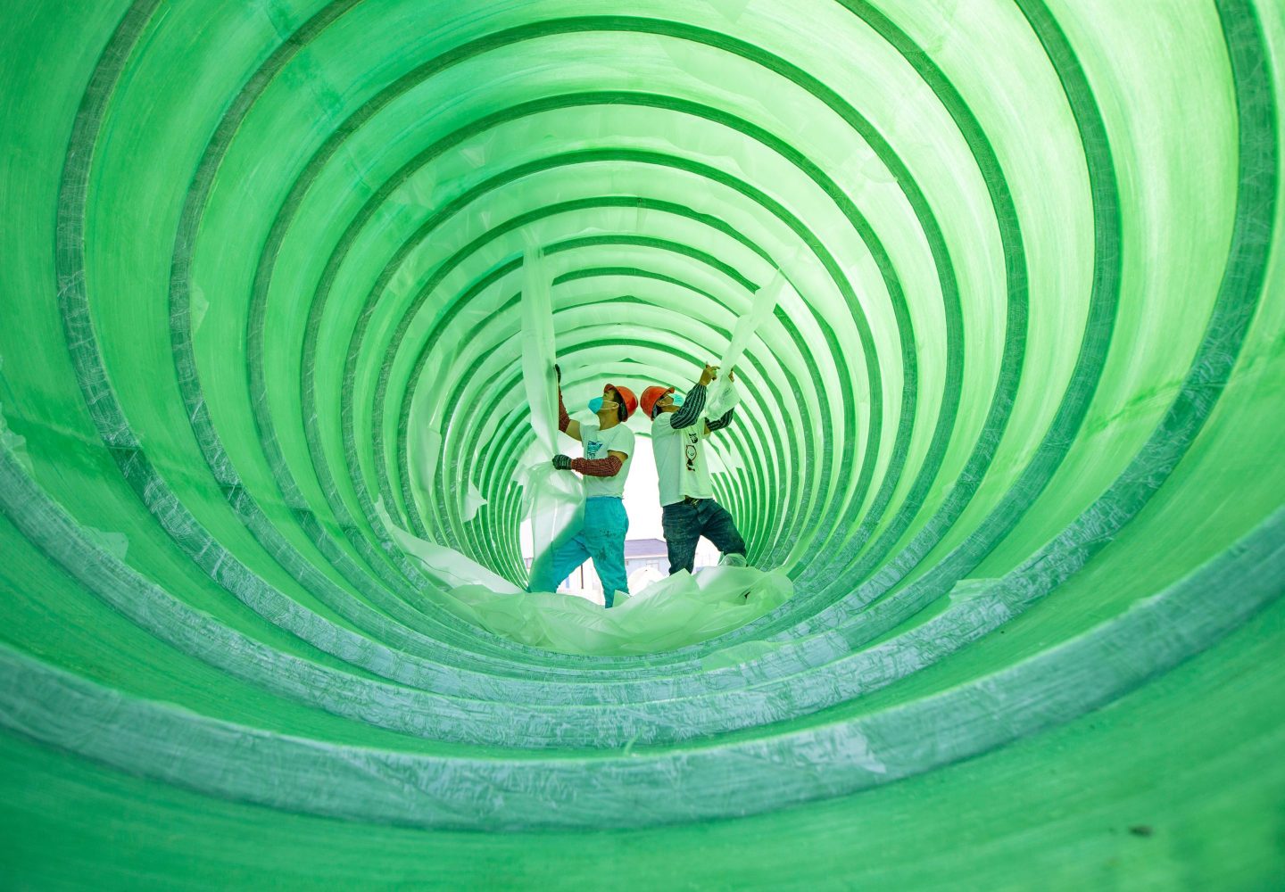 Workers manufacture sewage treatment equipment at Jiangsu Wushui Environmental Engineering Co., Ltd. on April 27 in Hai'an, Jiangsu Province of China. These sewage treatment equipment will be used in makeshift hospitals for COVID-19 patients.