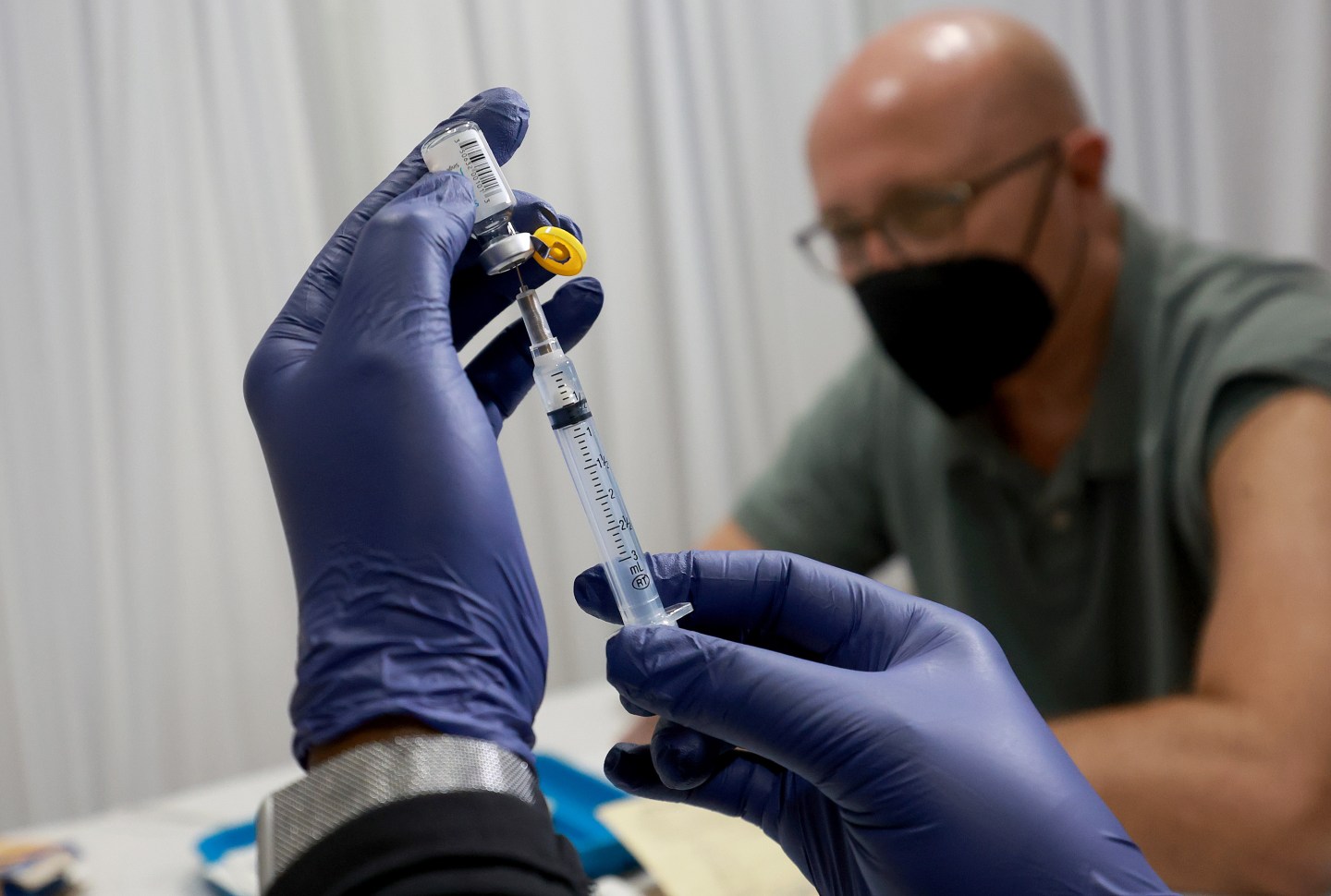 A healthcare worker prepares to administer a vaccine to Michael Nicot for the prevention of monkeypox the Pride Center on July 12 in Wilton Manors, Fla. The center is offering the free smallpox/monkeypox vaccinations from the Florida Department of Health in Broward County as South Florida leads the state in the number of people infected.