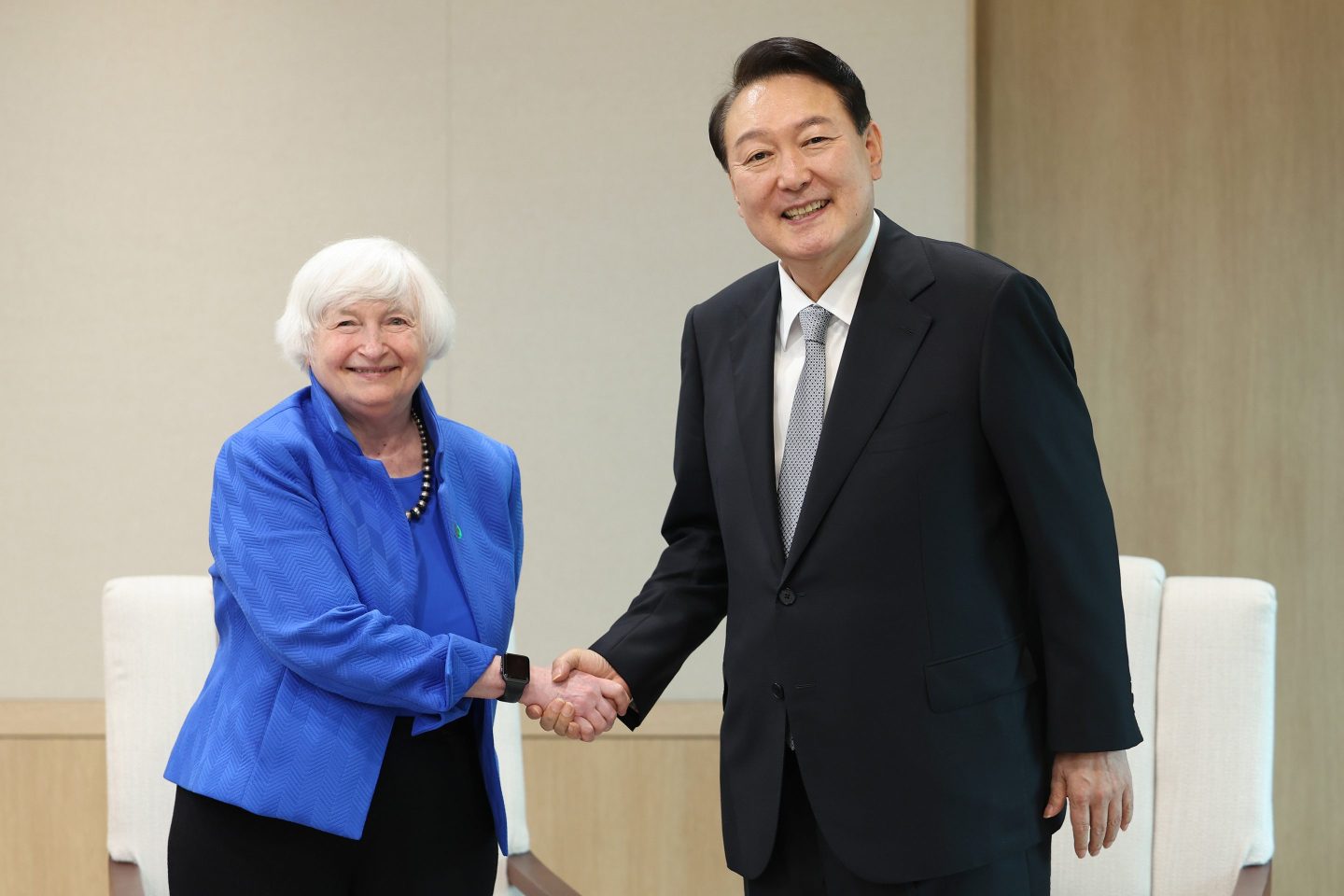 Photo of U.S. Treasury Secretary Janet Yellen and South Korean President Yoon Suk-yeol shaking hands in Seoul, South Korea, on July 19, 2022.