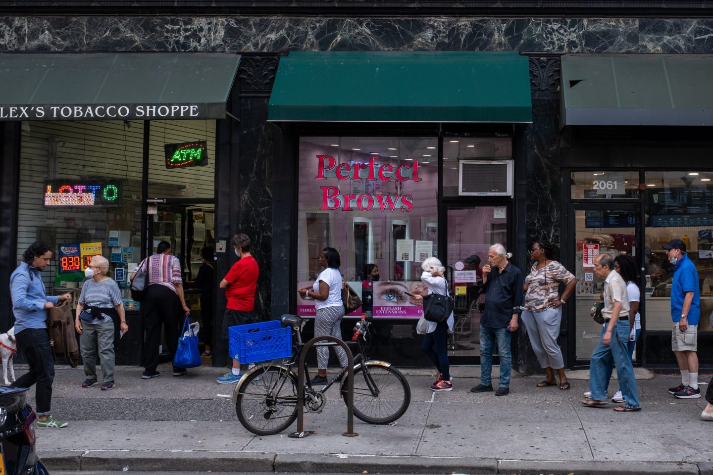 People wait in line to buy Mega Millions lottery tickets ahead of tonight's $830 million dollar jackpot drawing on July 26th in New York City.