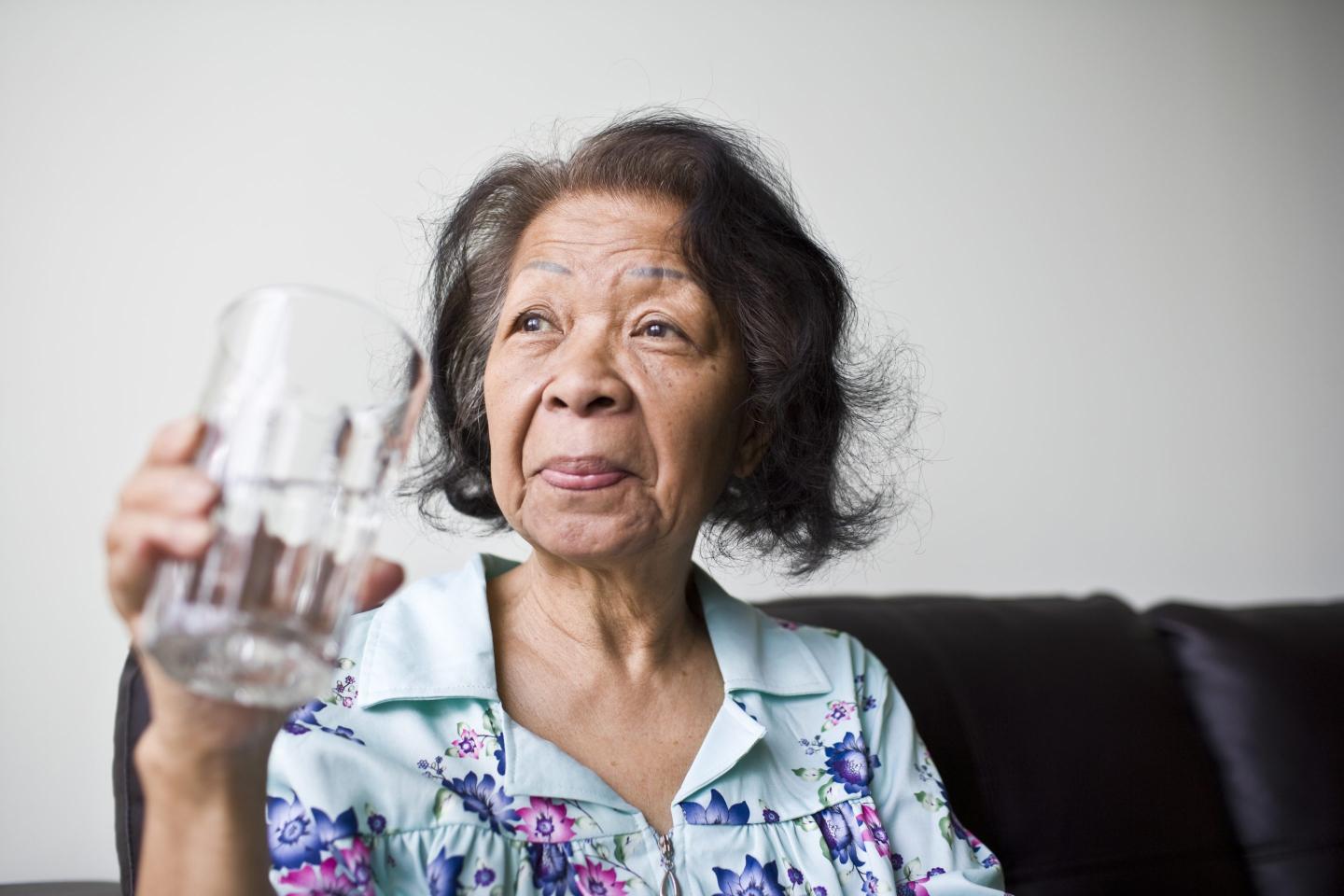 Senior woman holding a glass of water