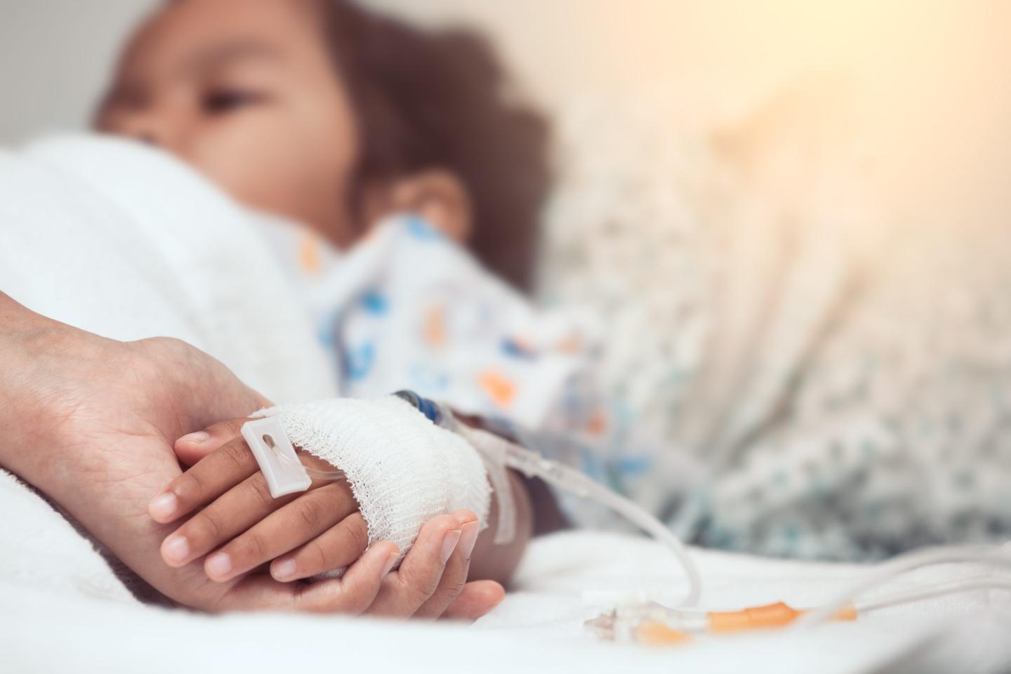 Mother holds child's hand