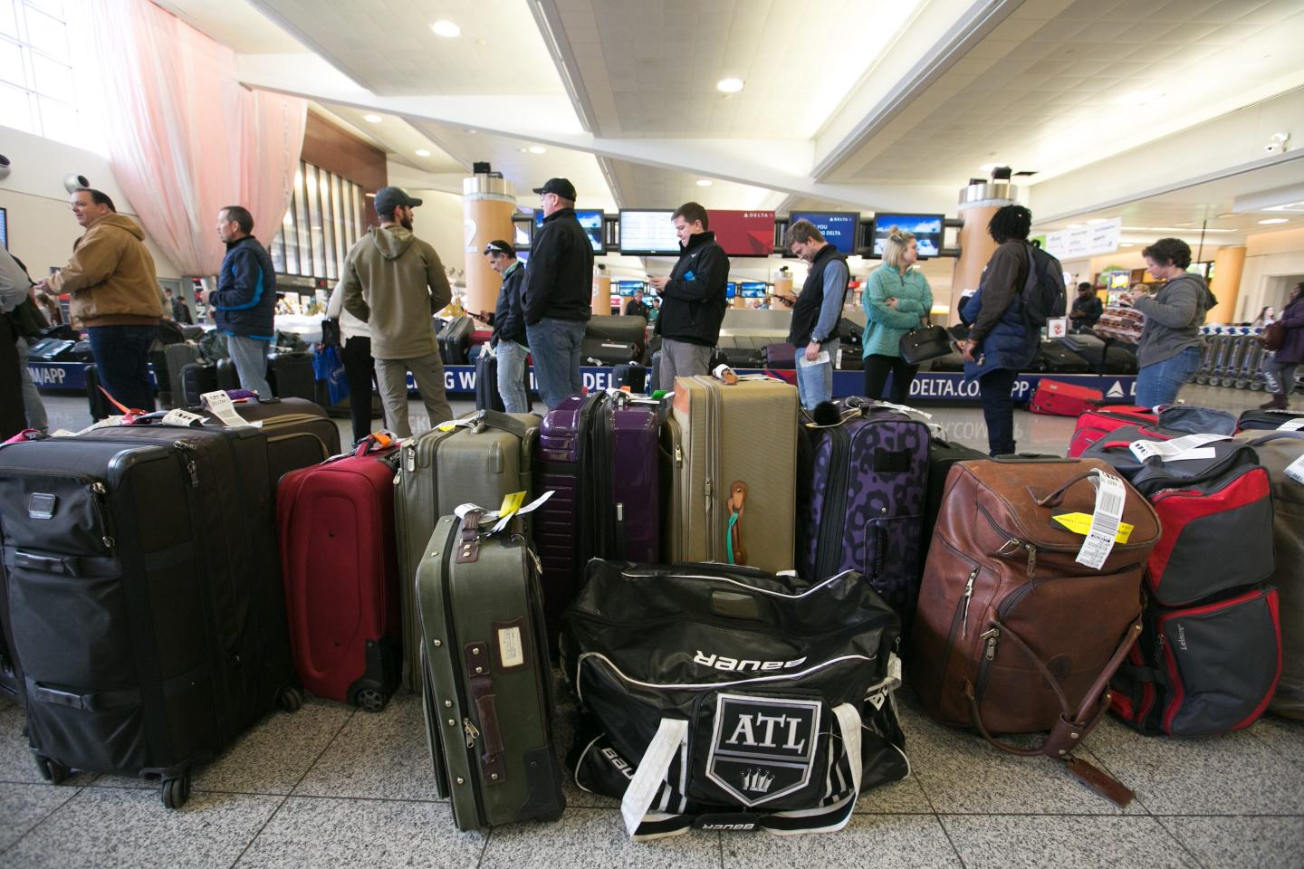 Passengers search for their luggage