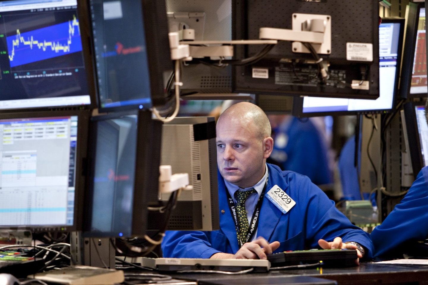 A stockbroker looks at a computer in the NYSE.