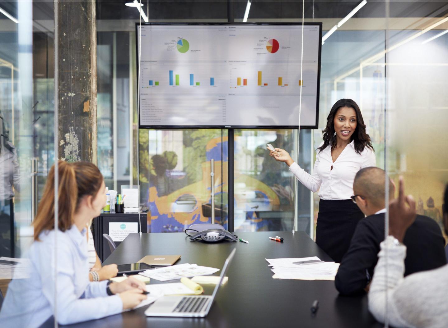 Businesswoman giving presentation during meeting in office