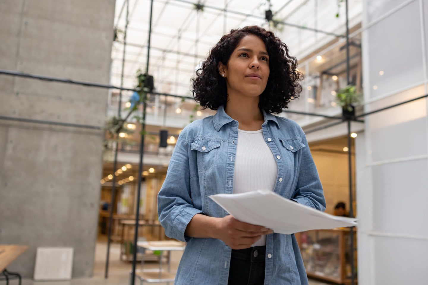 Woman holding cover letter and resume.