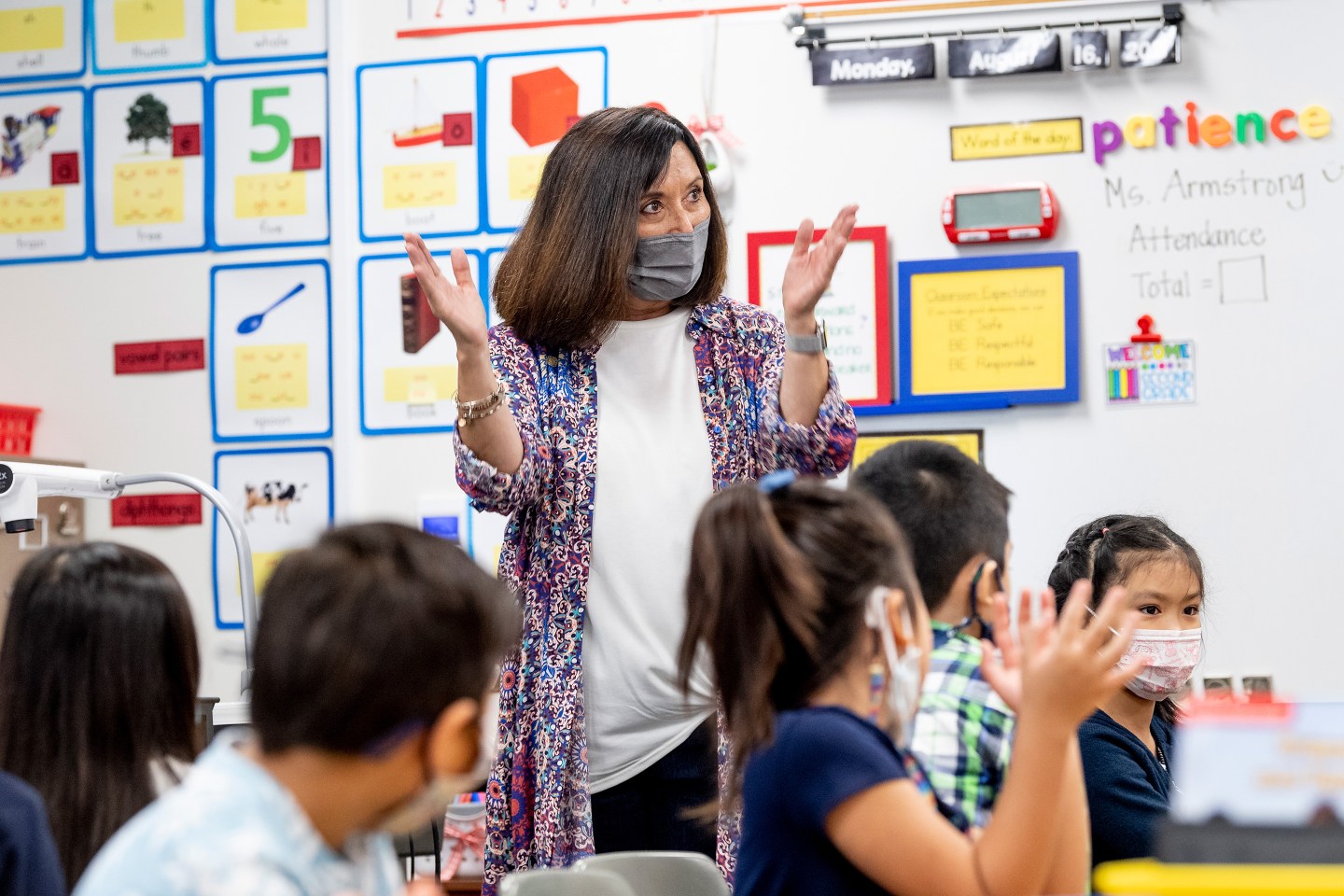 Teacher wearing mask with students.