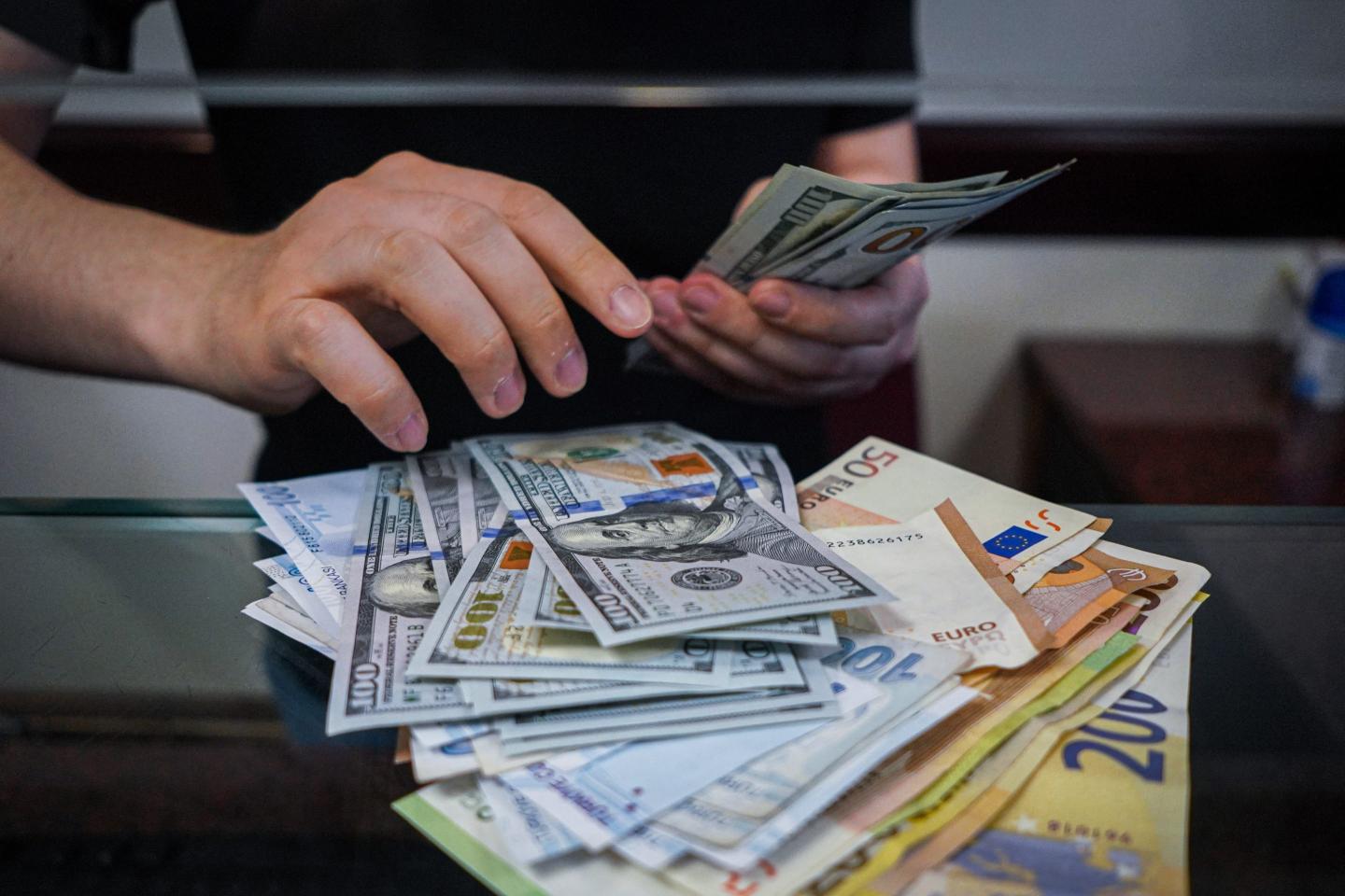 Euros and dollars begin counted.