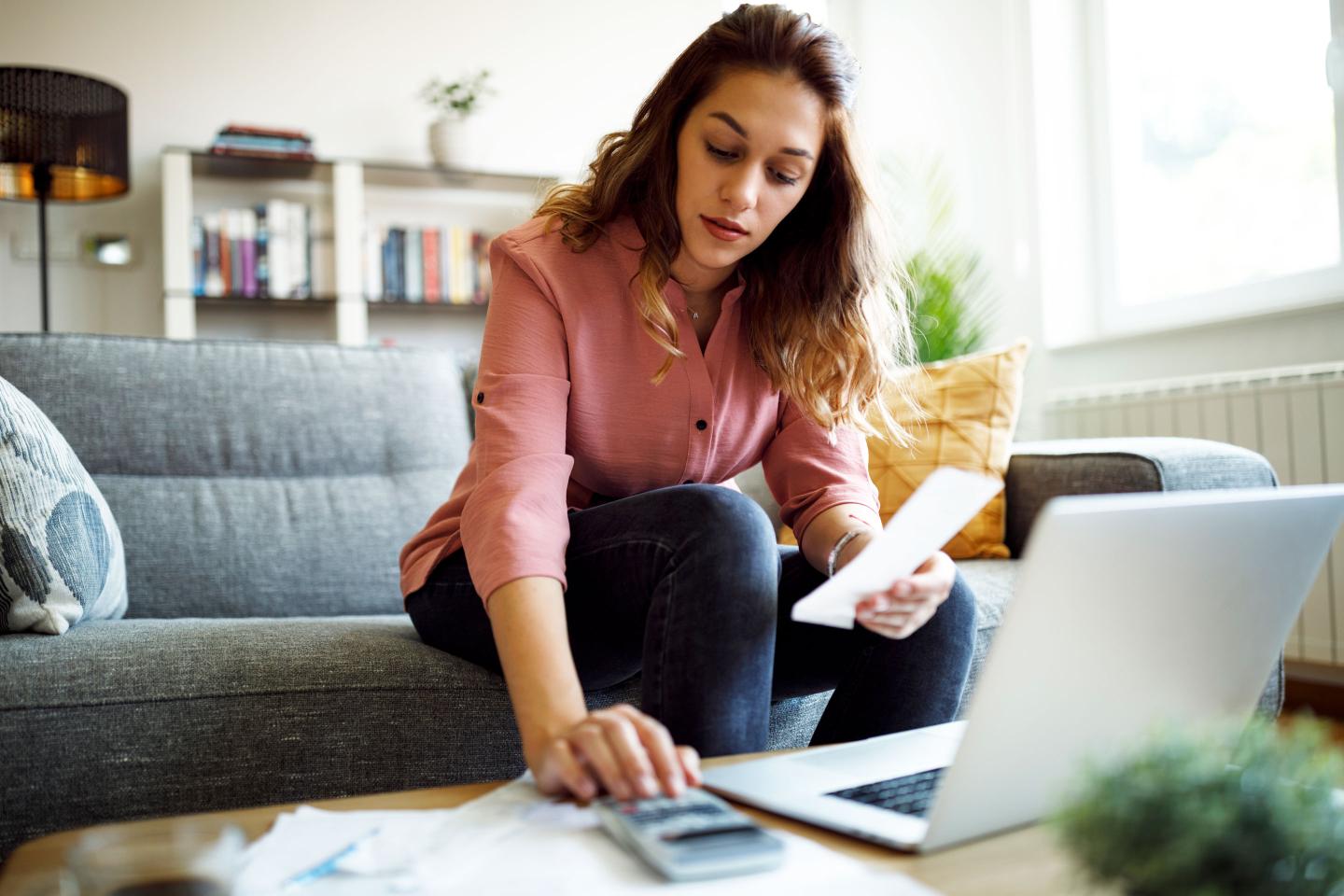 a young woman balancing her checkbook