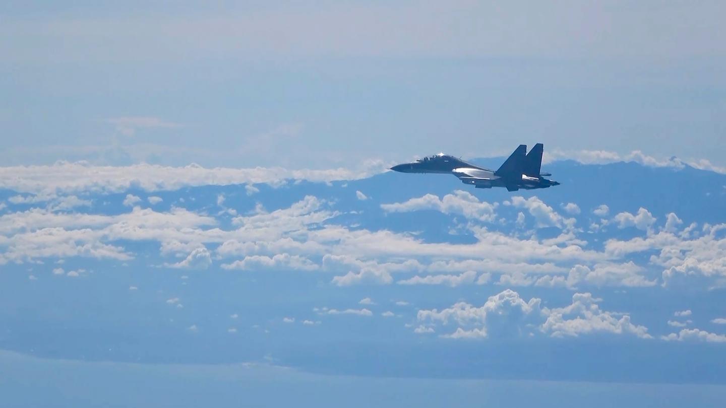 In this image made from video and released by China's Xinhua News Agency, a Chinese military plane flies during a training exercise of the air force corps of the Eastern Theater Command of the Chinese People's Liberation Army (PLA), Aug. 5.