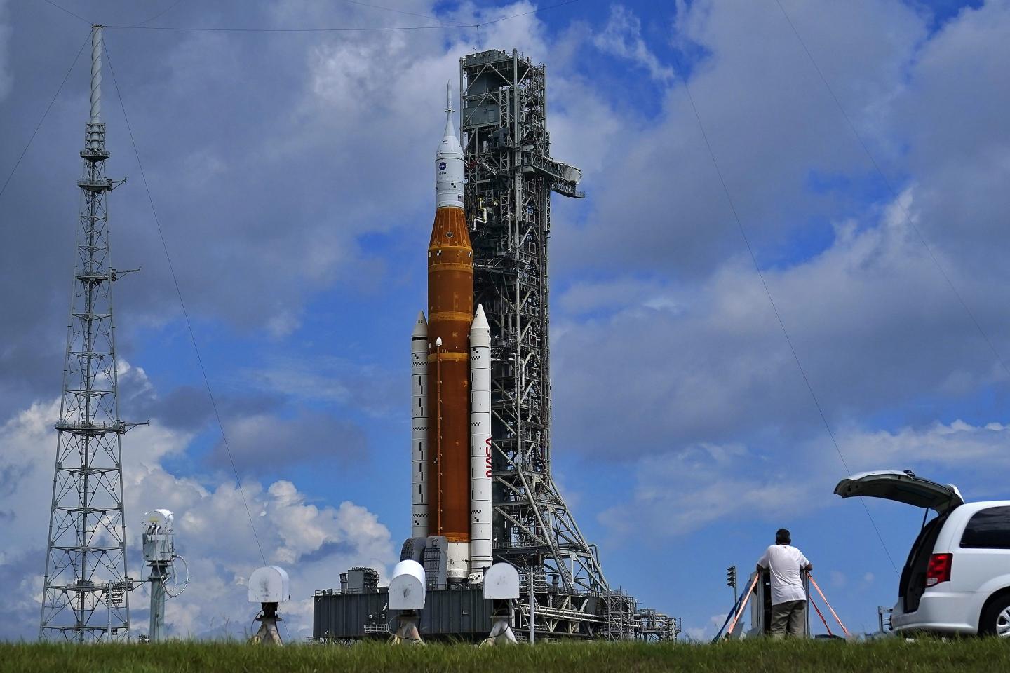 Photographers place remote cameras near the Artemis 1 rocket as she stands on Launch Pad 39-B at the Kennedy Space Center on Aug. 26 in Cape Canaveral, Fla. The launch is scheduled for Monday morning Aug. 29.