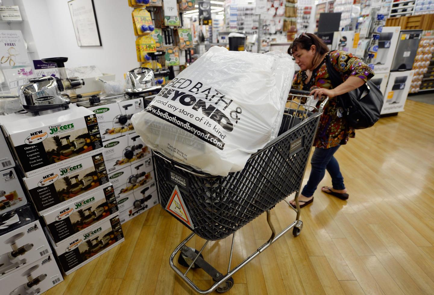 Customers carry bags from Bed Bath &amp; Beyond store on April 10, 2013 in Los Angeles, California.