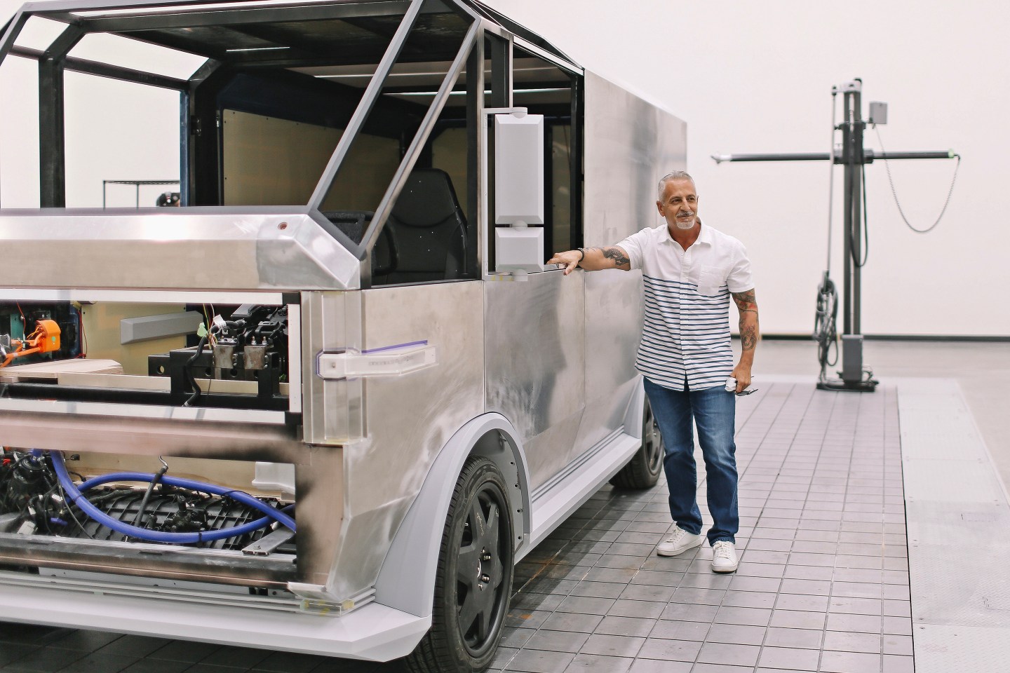 Canoo CEO Tony Aquila in front of the company's EV prototype.