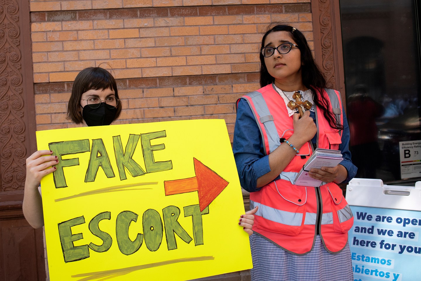 Abortion-rights and anti-abortion supporters stand outside of an abortion clinic.