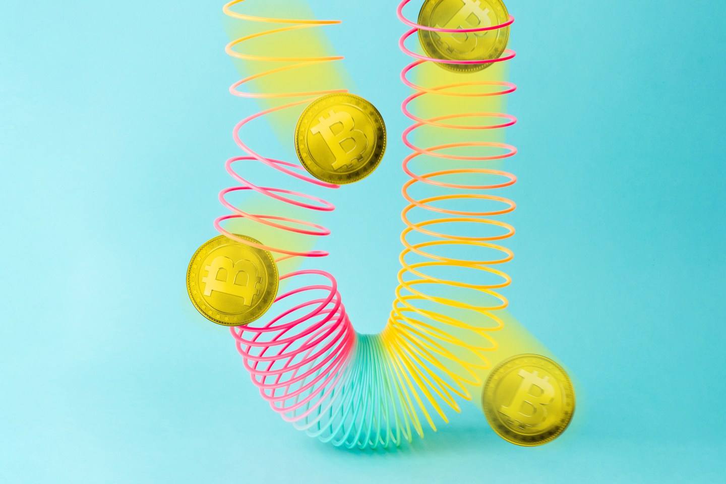 Bitcoin coins in a colorful slinky.