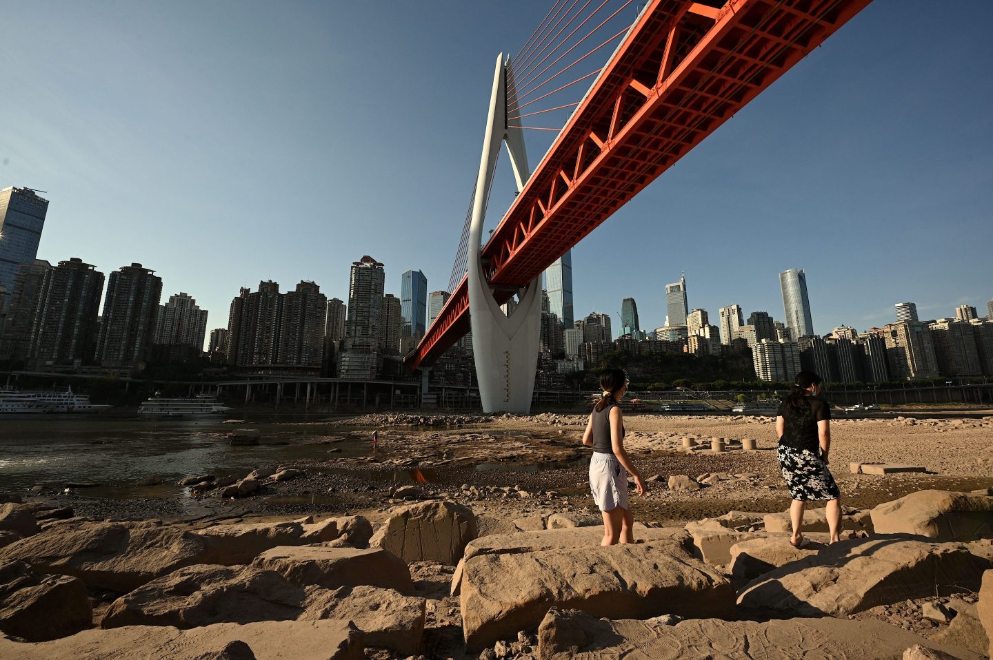 People on the dried-up riverbed of the Jialing River, a tributary of the Yangtze River, in China’s southwestern city of Chongqing on Aug. 24, 2022.