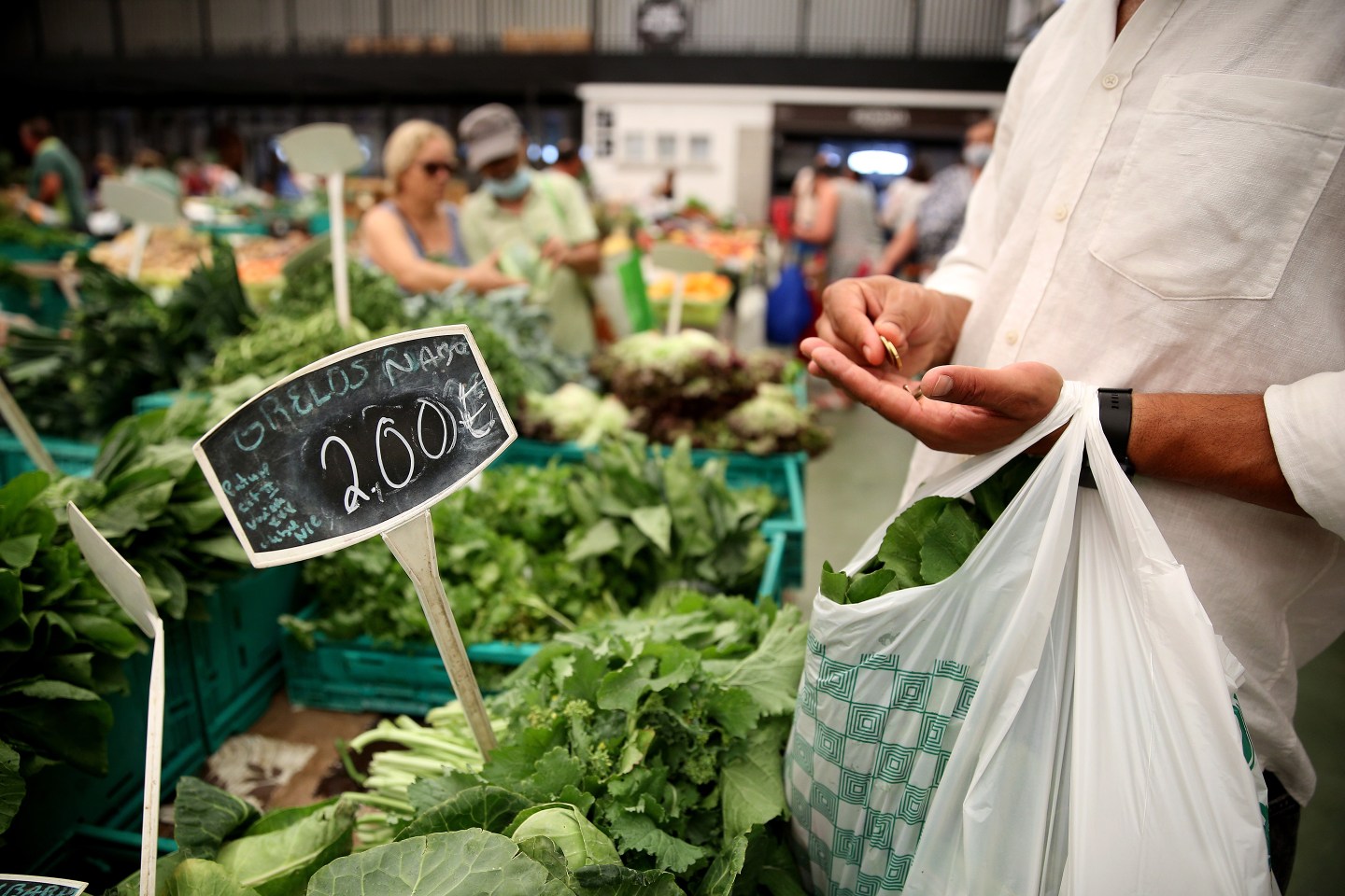 Customers shop at a market in Cascais, Portugal, on July 13, 2022.