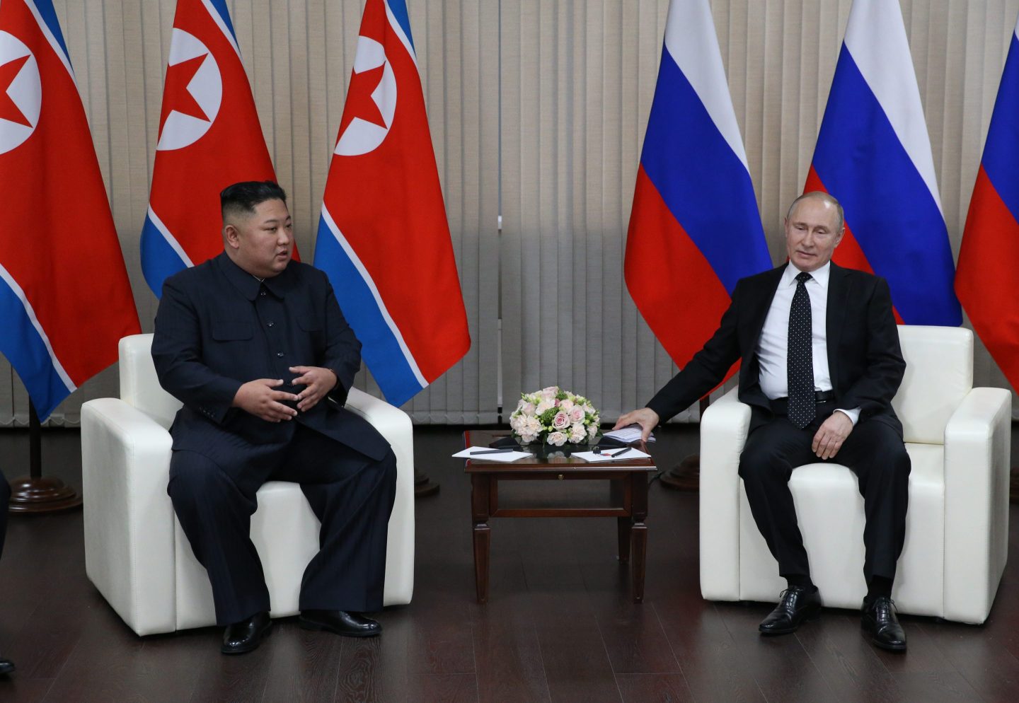 Russian President Vladimir Putin (R) talks with North Korean Leader Kim Jong-un during their meeting on April 25, 2019 in Vladivostok, Russia