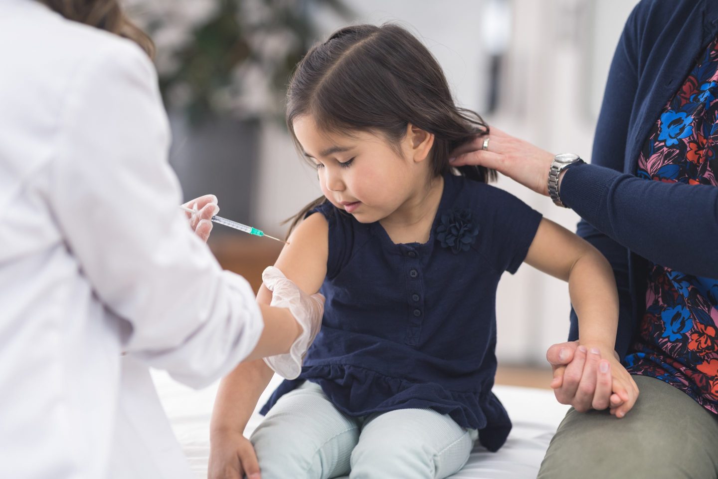 Young girl at the doctor's office getting a shot