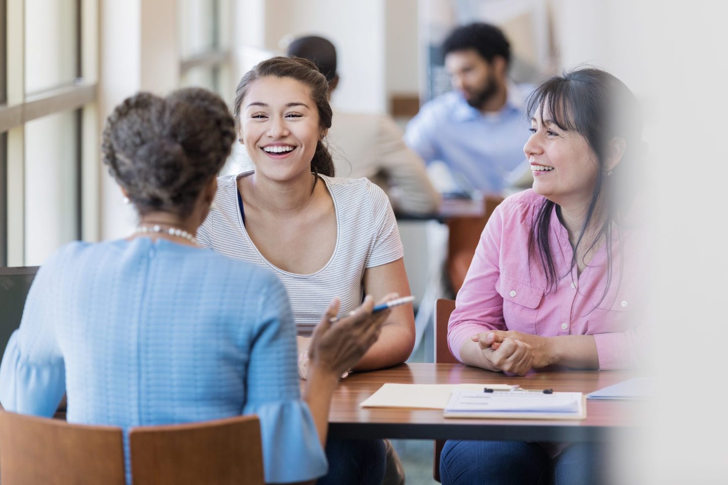 Loan officer discusses student loan with college student