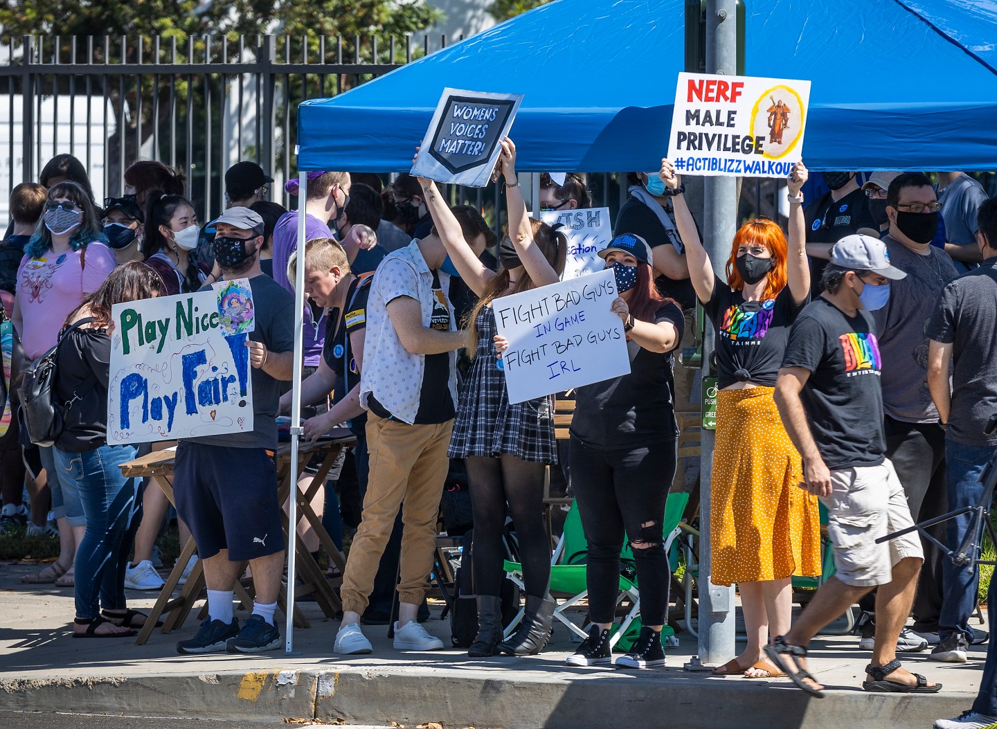 The image shows multiple Activision Blizzard employees protesting against sexism at the company.