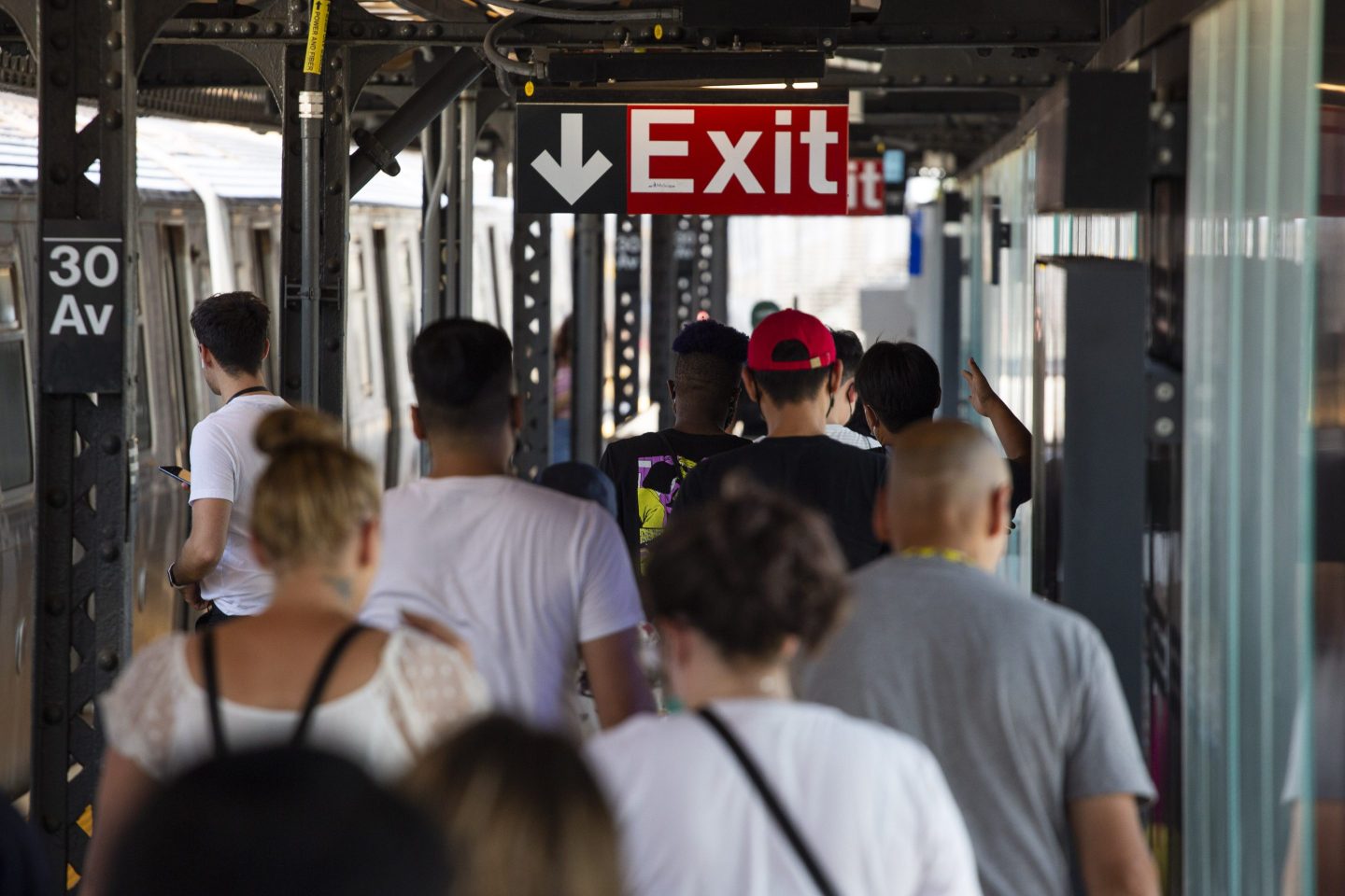 Commuters exit a subway station in the Queens borough of New York