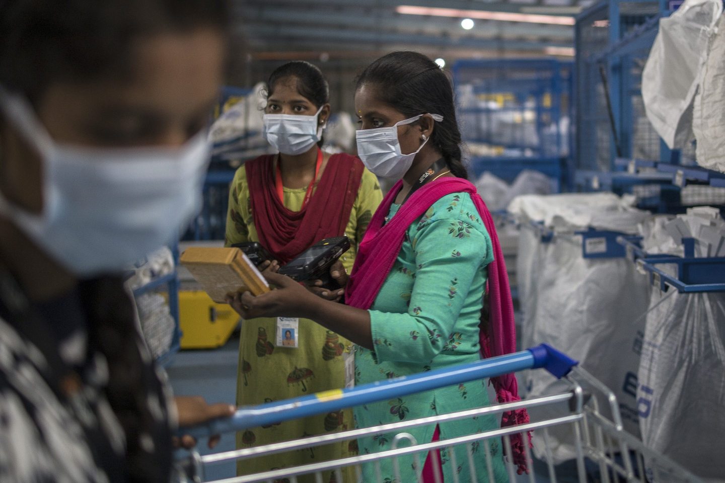 A worker wearing a protective mask scans a package at a warehouse owned by Walmart-backed e-commerce giant Flipkart in the outskirts of Chennai, India.