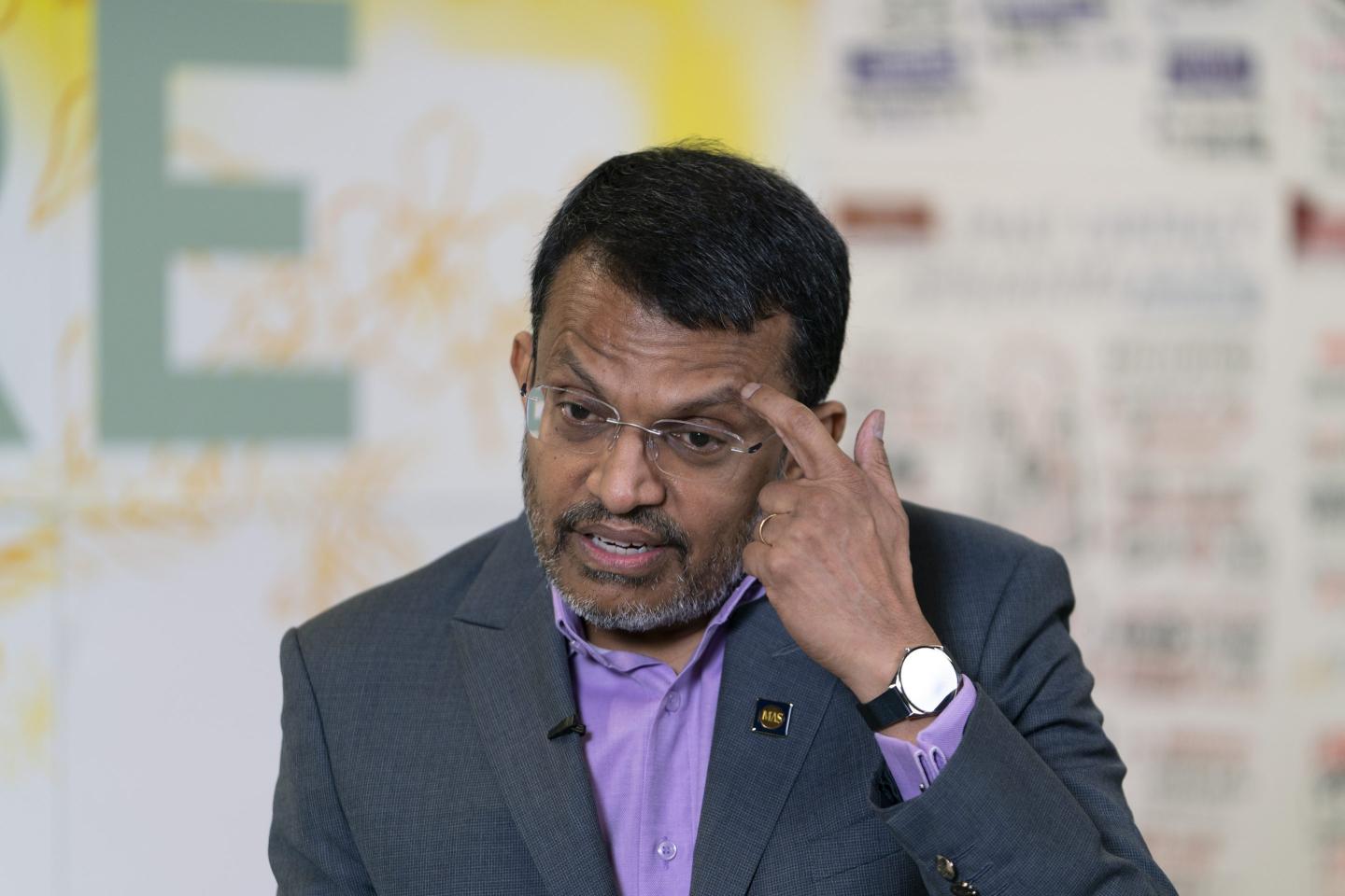 Monetary Authority of Singapore Managing Director Ravi Menon scratching his head