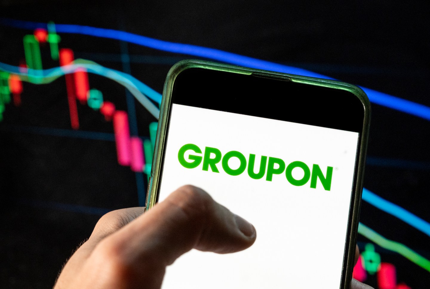 A phone with the Groupon logo.