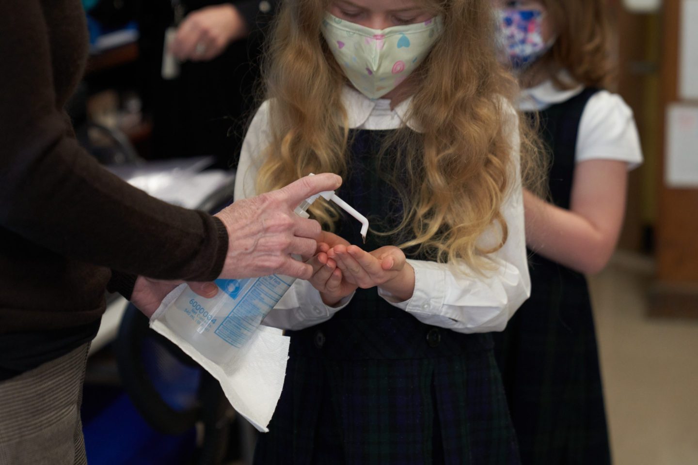A student sanitizes their hands after taking a Covid-19 test during pool testing at an elementary school in Boston, Massachusetts on Jan. 13.