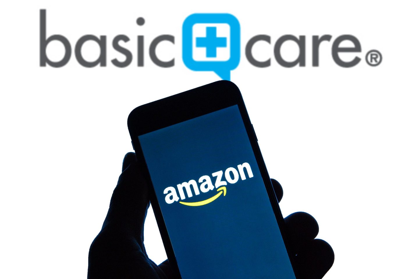 Amazon logo seen displayed on a smartphone with a Basic Care logo displayed in the background.