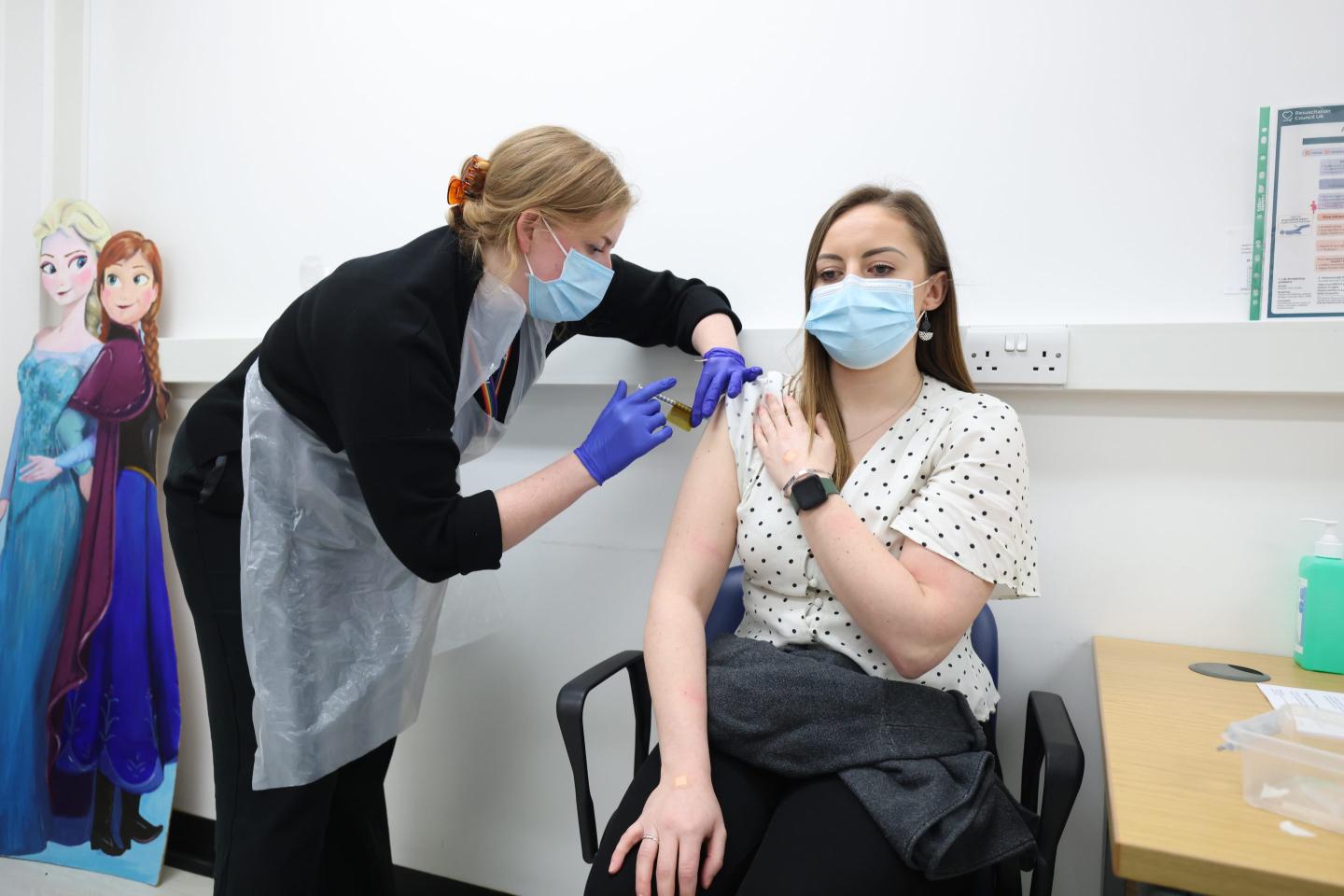 A woman receives Moderna's Omicron vaccine during a clinical trial.