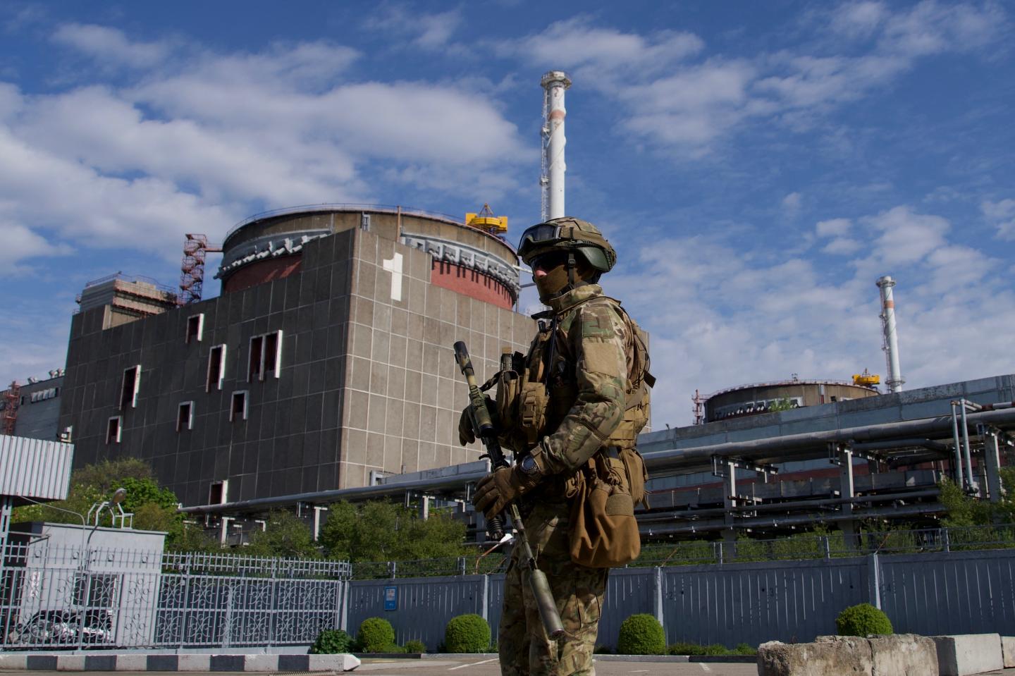 A Russian solider patrols the territory of the Zaporizhzhia Nuclear Power Station in Energodar on May 1, 2022