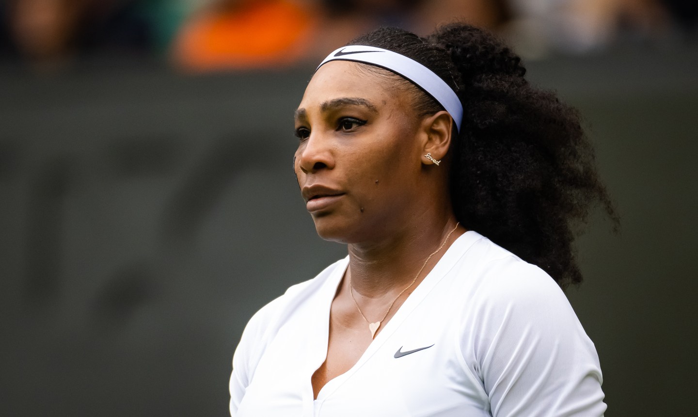Serena Williams on the court at Wimbledon 2022 wearing an all-white outfit.