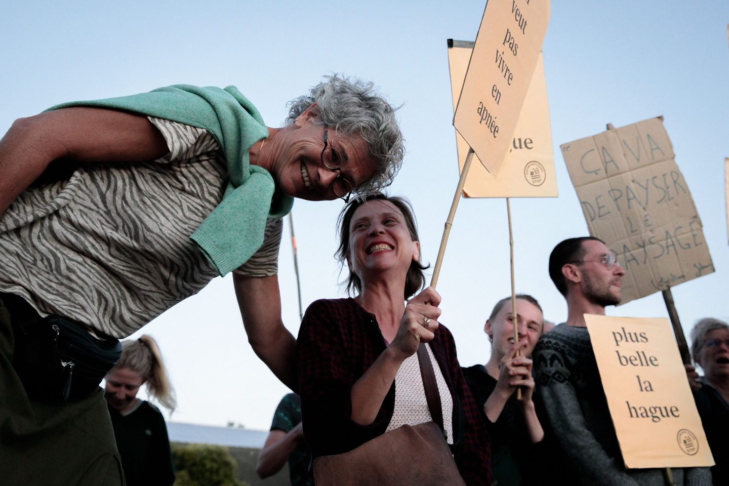 Protester hold signs, at Beaumont-Hague, northwestern France, on July 6 during a protest as part of a final public consultation meeting for the large nuclear fuel pool project.