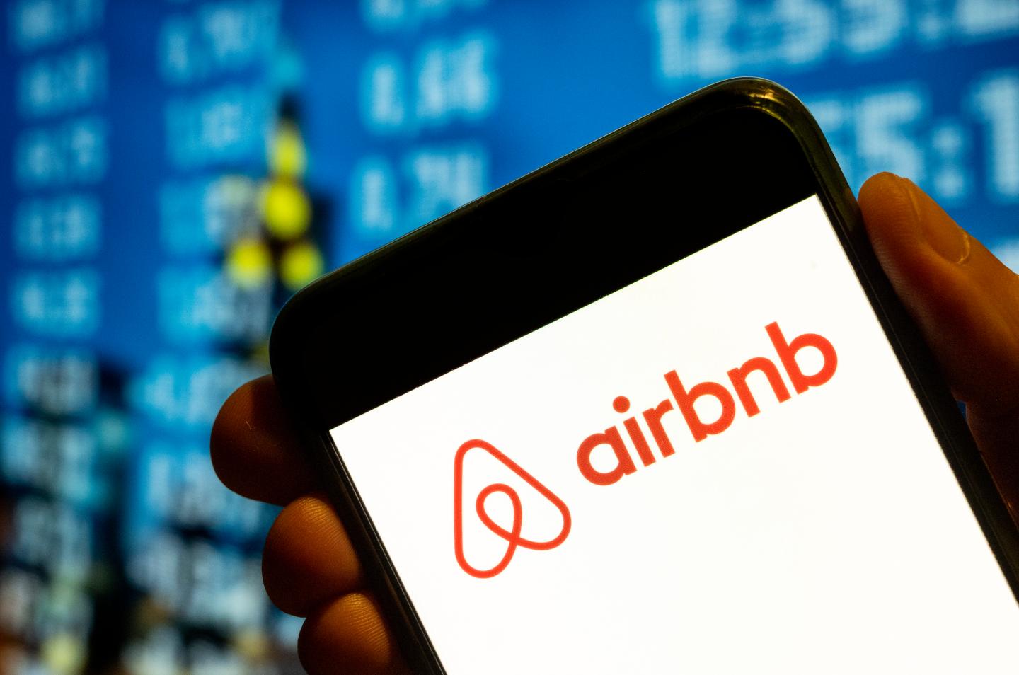Airbnb logo on a smartphone screen