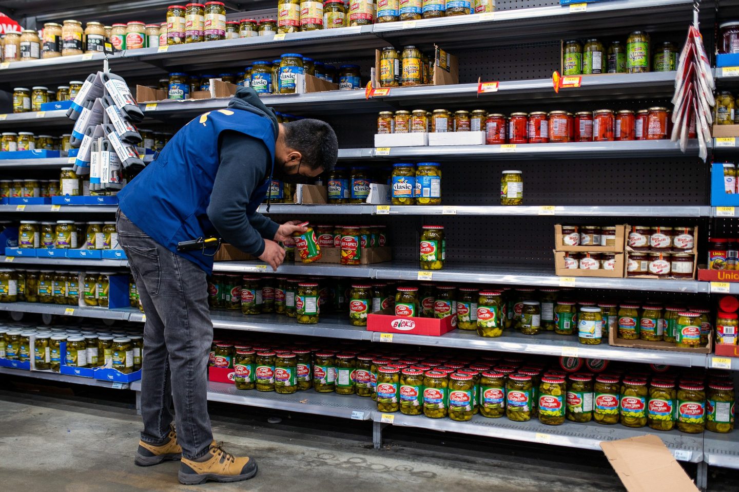 A worker stocks the shelves of a Walmart store in the Uptown Mall in Victoria, British Columbia, Canada.