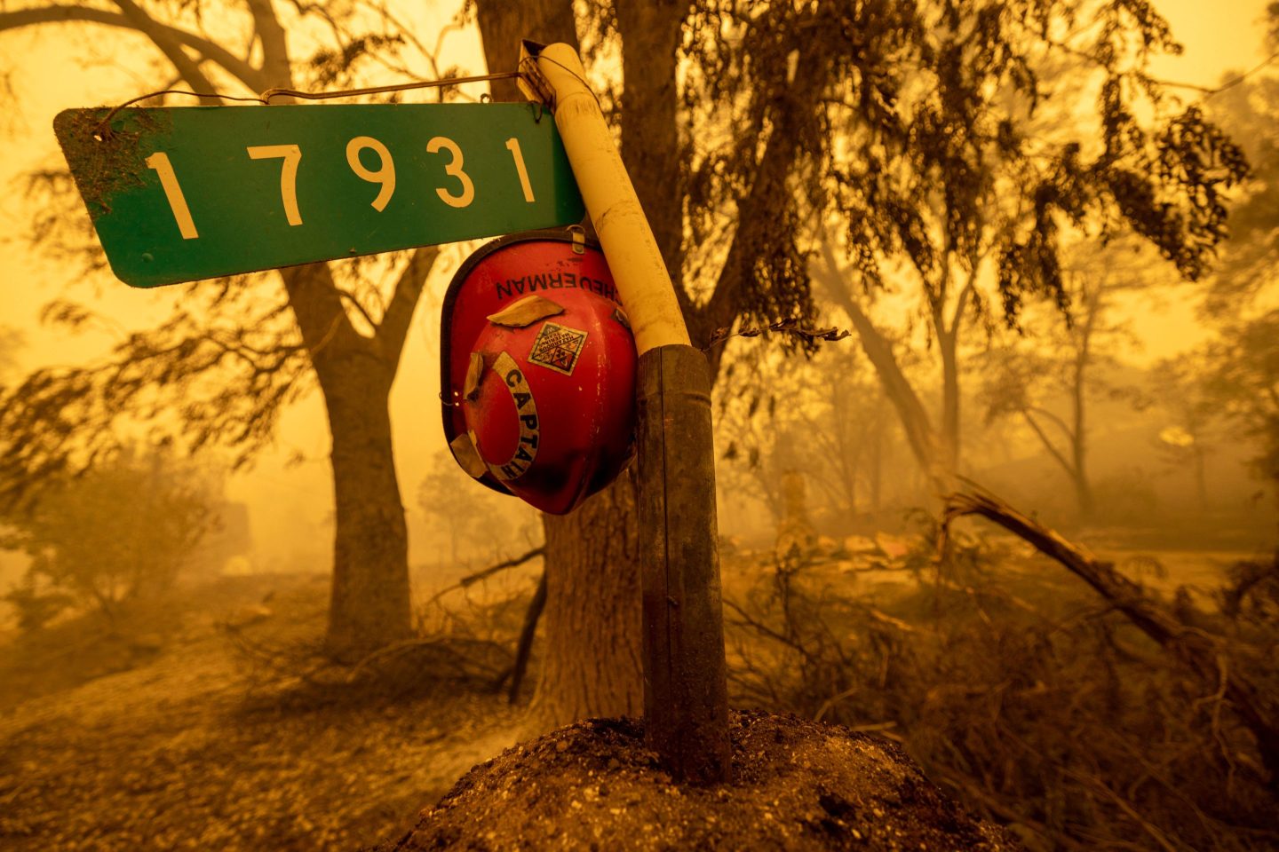 A firefighter helmet hangs at the entrance to a property