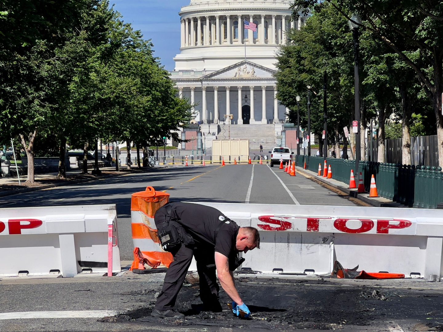 A U.S. Capitol Police Officer works near a police barricade on Capitol Hill in Washington, D.C., on August 14. -A man died early Sunday near the U.S. Capitol building after driving his car into a barricade and firing shots into the air before turning his gun on himself, police said.