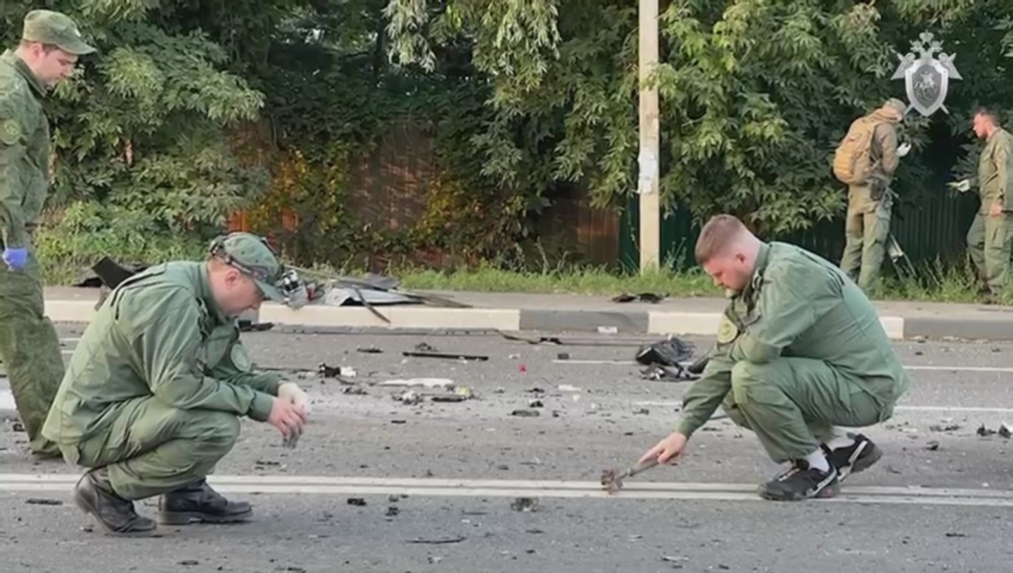 Russian officials investigate the scene after the car of Darya Dugina, daughter of Alexander Dugin, Russian political scientist and ally of President Vladimir Putin exploded on Mozhayskoye highway in Moscow, Russia on August 21, 2022.