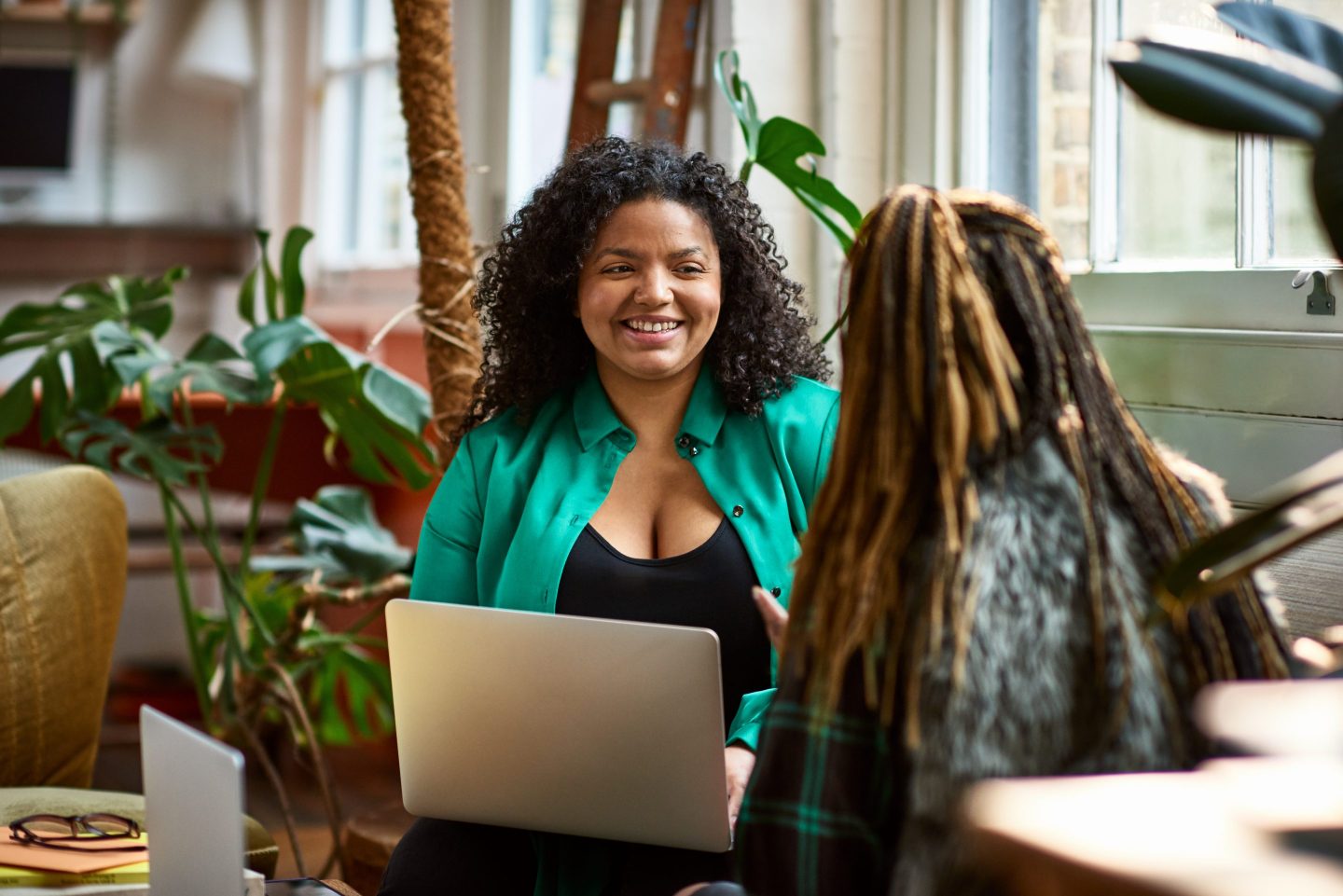 Woman sitting with coworker in office