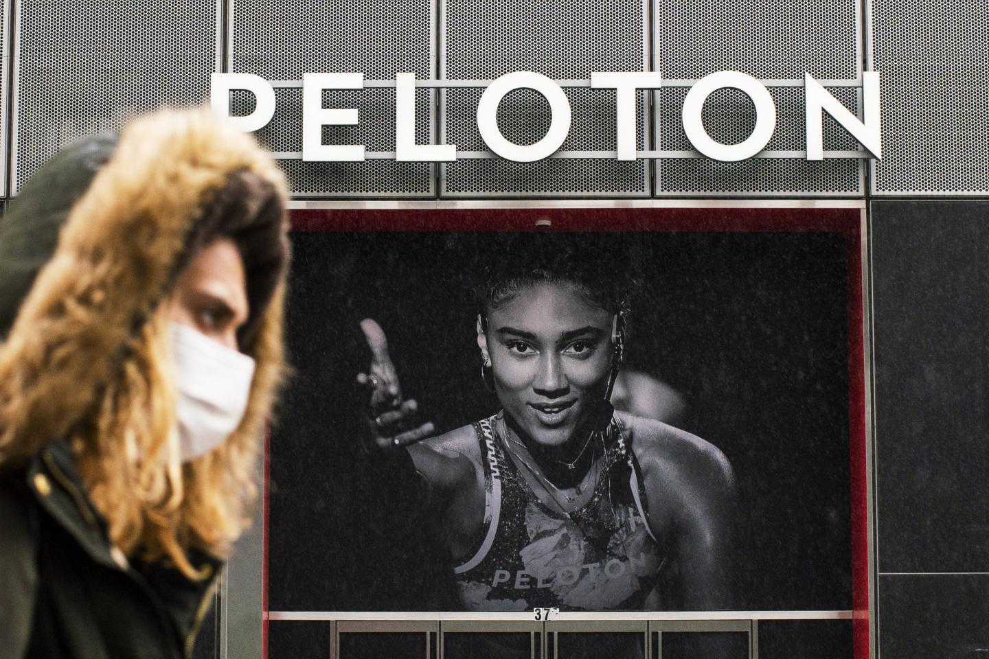 A woman walks in front of a Peloton store in Manhattan