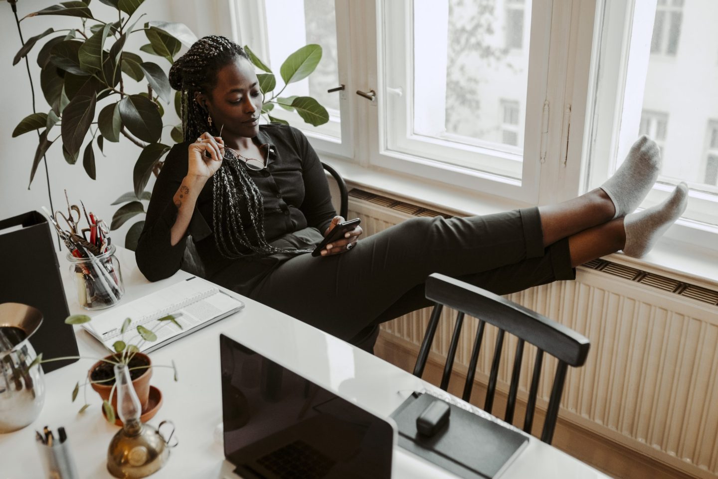 Young businesswoman texts while working