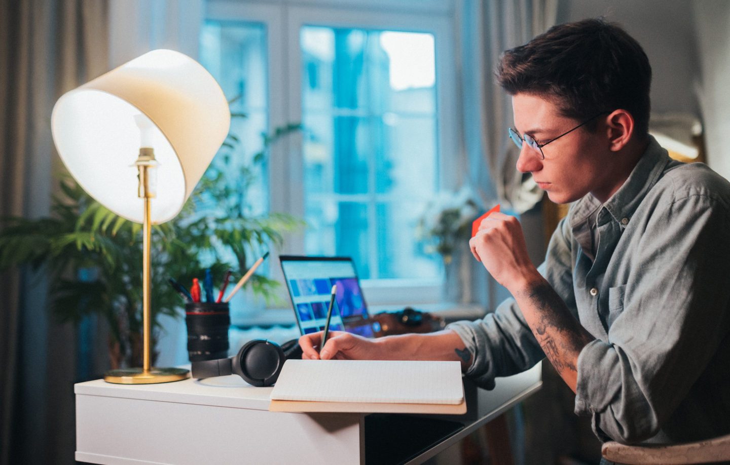 Man sitting in front of a computer paying for an online purchase with a credit card