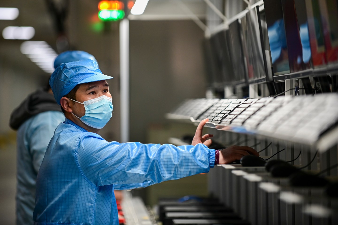 Employees work on the assembly line of computer at a computer manufacturing enterprise